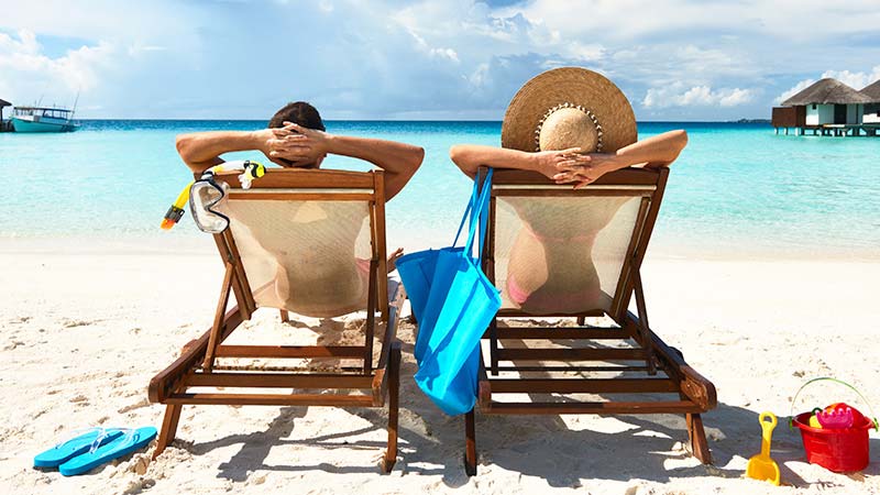 Man and woman relaxing on a beach.